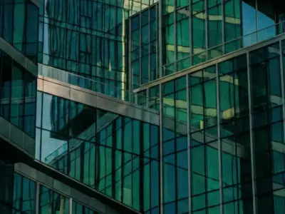 Modern glass skyscraper facades with teal reflections