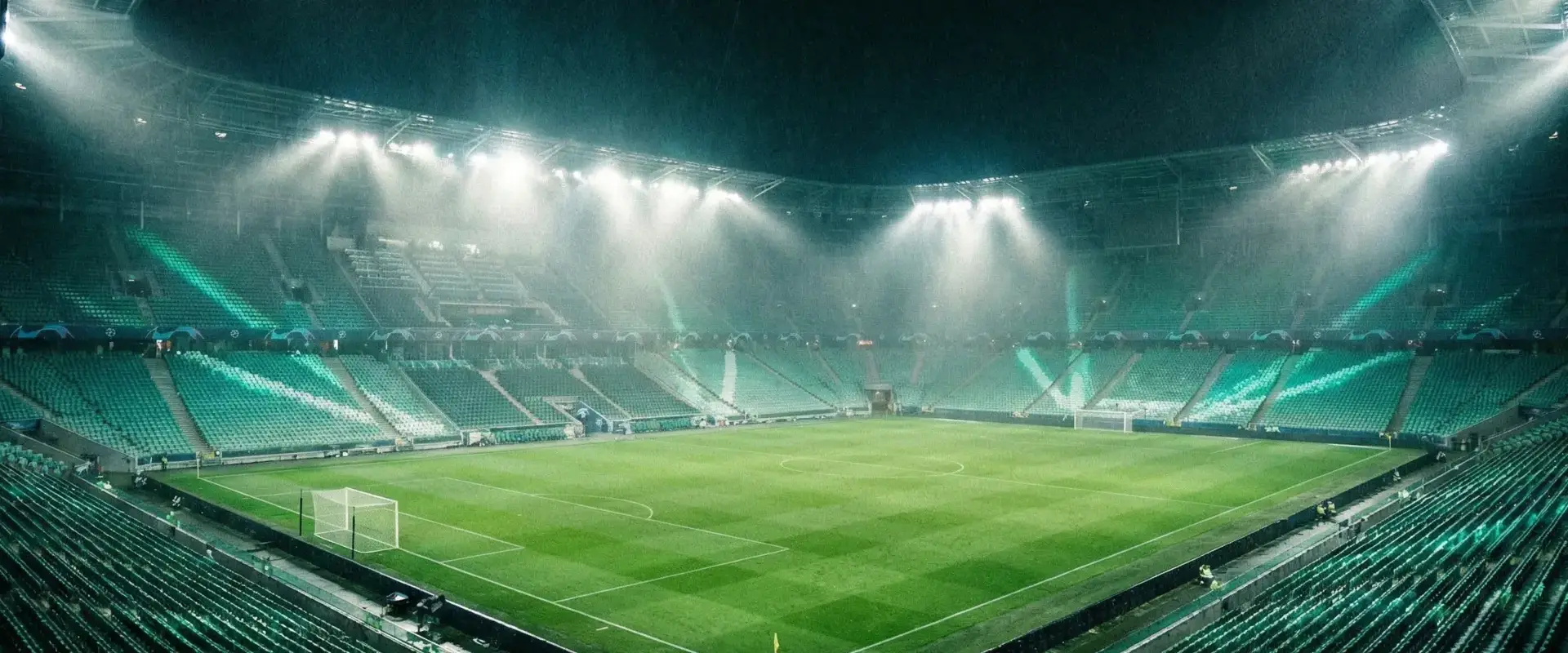 Football stadium at night with floodlights illuminating the pitch